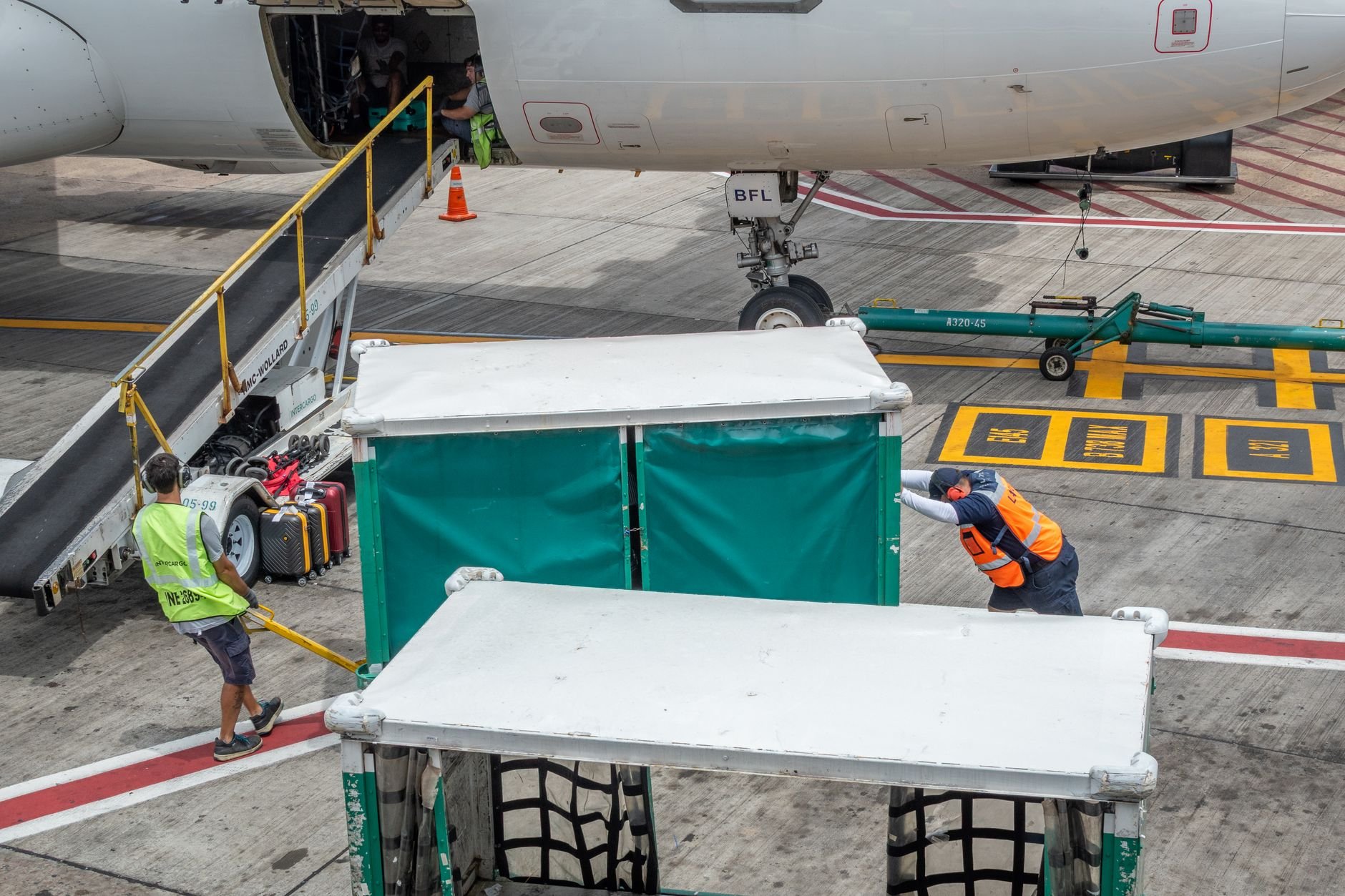 Ground crew at airport handling baggage for departing flight